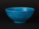 bowl with cracky blue glaze on a black background