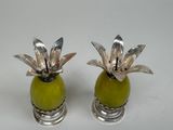 silver plated pineapple salt and pepper shakers on a white background