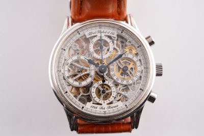 a close up of a watch with a brown leather strap