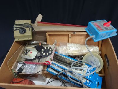 a box full of electronics and other items on a table