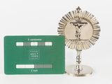 a silver plate with a green credit card next to it