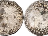 an old silver coin with a crown on the front and a shield on the back