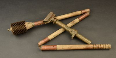 three old wooden tools are laying on a black surface