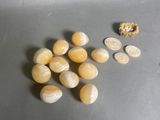 some yellow and white stones and a coin on a table