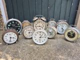 a lot of clocks sitting on the ground in front of a door