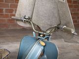 a scooter that is parked in front of a brick wall