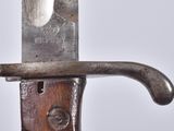 a close up of a knife on a wooden handle