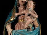 a statue of a woman holding a child in her lap