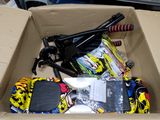 a cardboard box filled with assorted skateboards and other items