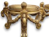 a gold table with a bowl on top of it
