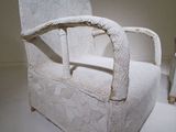 a white chair that is on display in a room
