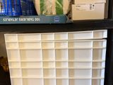 a shelf full of boxes and other items on the floor