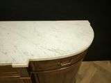 a marble counter top with a wooden cabinet in the background
