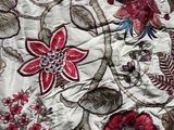 an image of a close up of a quilt with flowers on it