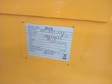 the back end of a yellow machine with a sticker on it