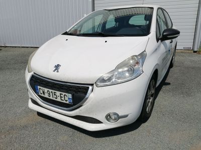 the small white car is parked in front of a building
