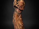 a carved wooden statue of a woman holding a child