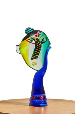 a glass sculpture of a fish with a tie on it