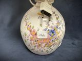 a white vase with a floral design on it
