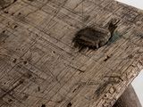 a close up of a wooden bench with holes in it
