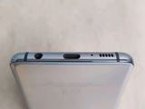 a close up of the back of a silver cell phone