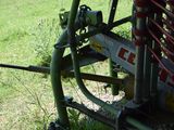 a close up view of a machine that is parked in the grass