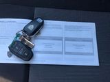 a car key sitting on top of a piece of paper next to a car key