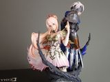 a figurine of a woman and a man sitting on a book