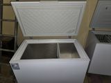 a white chest freezer sitting in a room