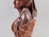 a brown busturine of a woman on a clear base