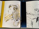 a book opened to show a drawing of a woman and a man