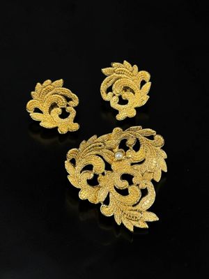 a pair of gold plated brooches and earrings