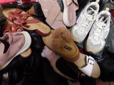 many pairs of shoes that are sitting on a pile of shoes