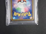 a close up of a pokemon trading card in a clear case