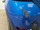 a close up of a blue car with a sticker on it