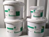 three buckets of white paint sitting next to each other on a table