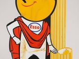 un panneau jaune et rouge représentant un personnage de dessin animé tenant un trophée