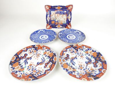 three plates and a picture frame sitting on top of a table