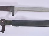 two knives that are sitting side by side on a white surface