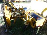 a yellow machine that is sitting in the grass