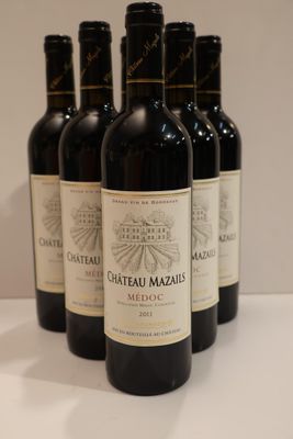 six bottles of red wine are lined up on a table