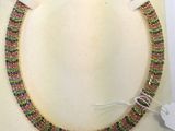 a close up of a necklace on a white surface