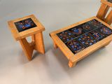 two wooden tables and a small table with tile on them