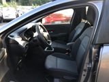 the interior of a car with the door open and the driver ' s seat down