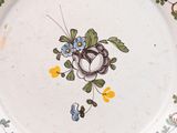 a white plate with a flower design on it