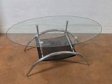 a glass table with metal legs and a glass top