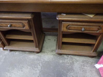 two wooden desks with drawers on them in a room