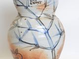 a ceramic vase with a blue and white design on it