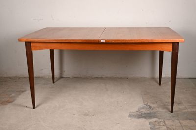 a wooden table with two leaves on it in a room