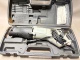 a small electric drill in a case with a cord